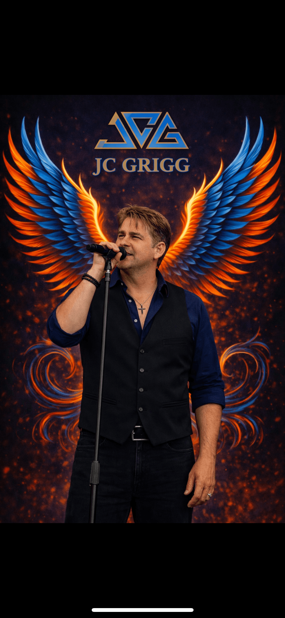 JC Grigg performing with phoenix wings and JCG logo - rising from ashes